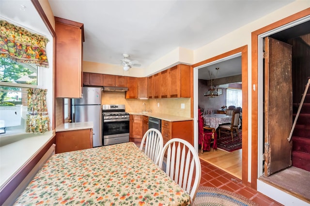 9 Forest Rd, Kings Park, NY 11754 - kitchen with appliances with stainless steel finishes, brown cabinetry, light countertops, and under cabinet range hood
