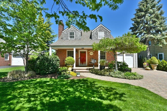 1515 Lowell Ave, New Hyde Park, NY 11040 - view of front of home with a chimney, decorative driveway, a front lawn, a shingled roof, and covered porch