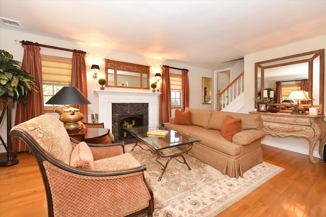 1515 Lowell Ave, New Hyde Park, NY 11040 - living room featuring wood finished floors, plenty of natural light, and stairs
