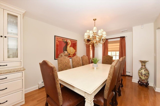 1515 Lowell Ave, New Hyde Park, NY 11040 - dining area featuring a baseboard radiator, a chandelier, light wood finished floors, and baseboards