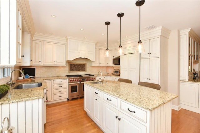 1515 Lowell Ave, New Hyde Park, NY 11040 - kitchen featuring double oven range, a sink, light wood-style floors, tasteful backsplash, and recessed lighting