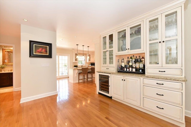 1515 Lowell Ave, New Hyde Park, NY 11040 - indoor dry bar featuring wine cooler, light wood-type flooring, baseboards, decorative light fixtures, and recessed lighting