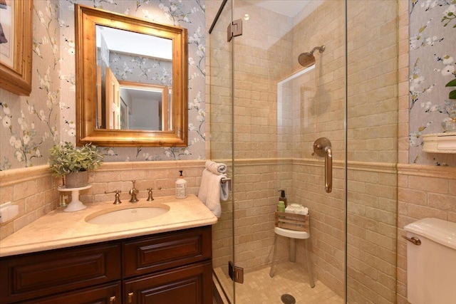 1515 Lowell Ave, New Hyde Park, NY 11040 - bathroom with tile walls, a shower stall, wallpapered walls, vanity, and toilet