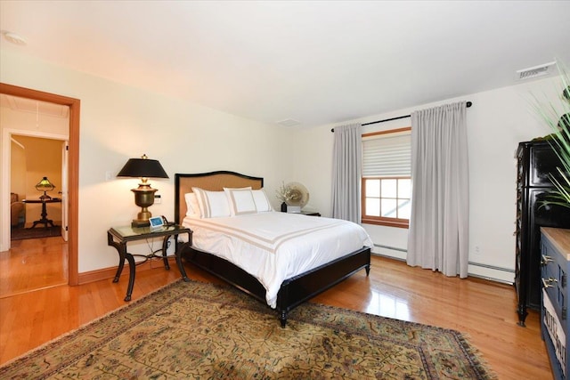 1515 Lowell Ave, New Hyde Park, NY 11040 - bedroom with a baseboard heating unit, wood finished floors, and baseboards