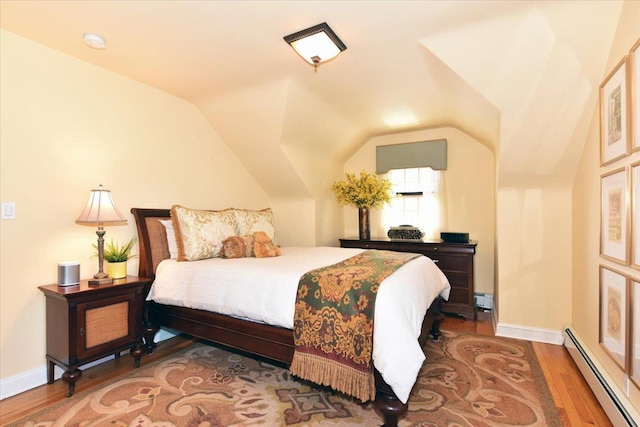 1515 Lowell Ave, New Hyde Park, NY 11040 - bedroom featuring baseboard heating, wood finished floors, lofted ceiling, and baseboards