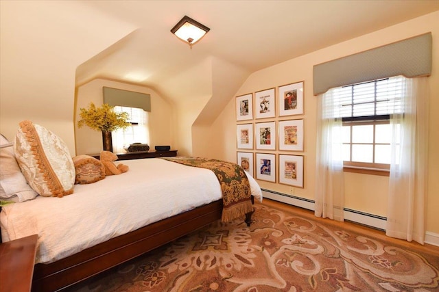 1515 Lowell Ave, New Hyde Park, NY 11040 - bedroom featuring wood finished floors, vaulted ceiling, and a baseboard radiator