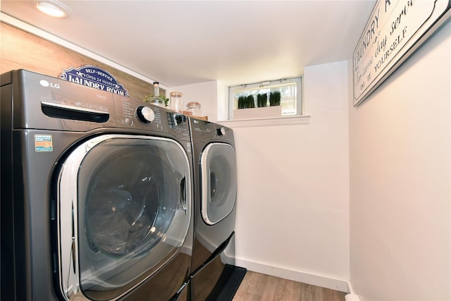 1515 Lowell Ave, New Hyde Park, NY 11040 - clothes washing area featuring washing machine and clothes dryer, wood finished floors, and baseboards