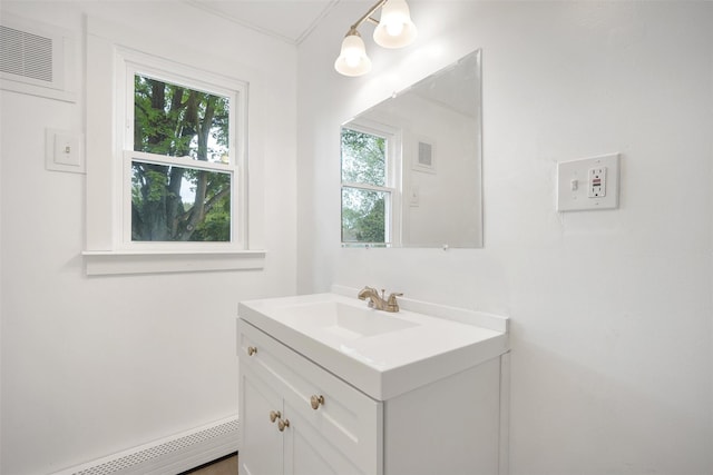 bathroom with baseboard heating and vanity