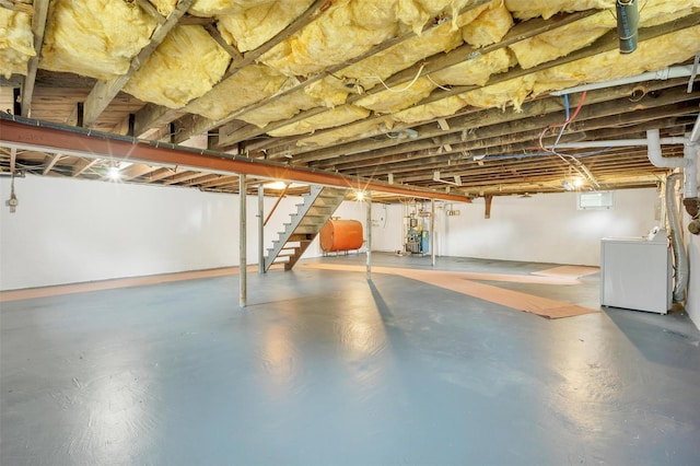 basement featuring washer / clothes dryer, heating fuel, and stairs