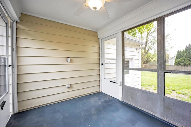 unfurnished sunroom with a ceiling fan