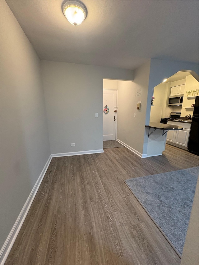 2107 Wallace Ave Unit 6E, Bronx, NY 10462 - unfurnished living room featuring dark wood-type flooring and baseboards