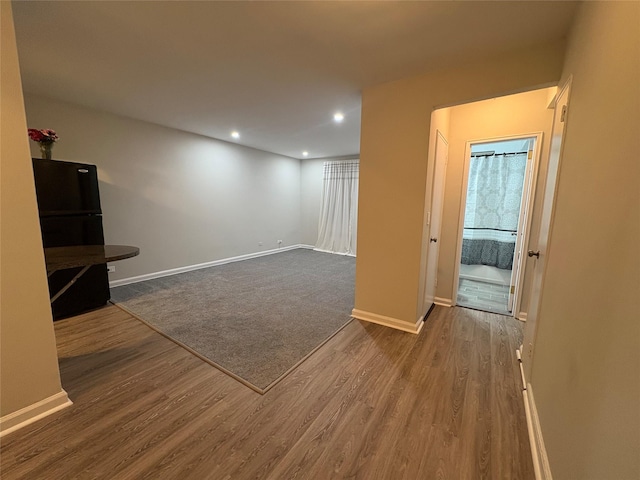 2107 Wallace Ave Unit 6E, Bronx, NY 10462 - basement featuring freestanding refrigerator, wood finished floors, baseboards, and recessed lighting