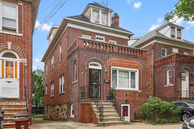 332 E 240th St, Bronx, NY 10470 - view of front of home featuring brick siding and a chimney