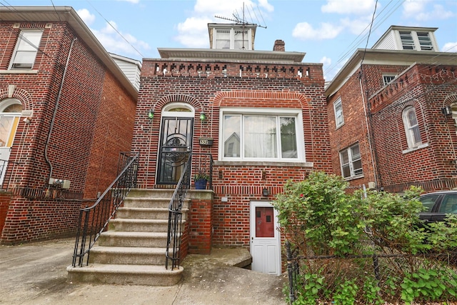 332 E 240th St, Bronx, NY 10470 - view of front facade with brick siding and a chimney