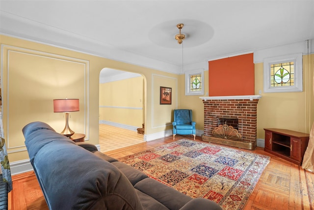 332 E 240th St, Bronx, NY 10470 - living area featuring arched walkways, healthy amount of natural light, a fireplace, and baseboards