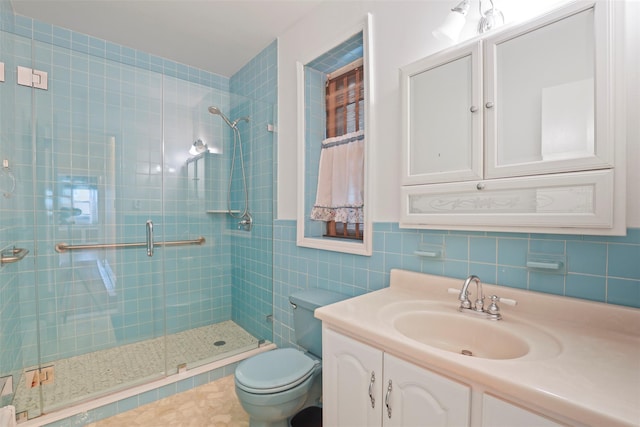 332 E 240th St, Bronx, NY 10470 - bathroom featuring toilet, a stall shower, tile walls, and vanity