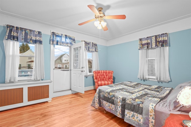 332 E 240th St, Bronx, NY 10470 - bedroom with wood finished floors, a ceiling fan, and radiator