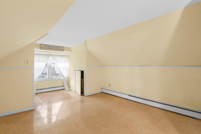 332 E 240th St, Bronx, NY 10470 - bonus room featuring a baseboard radiator, lofted ceiling, baseboards, and tile patterned floors