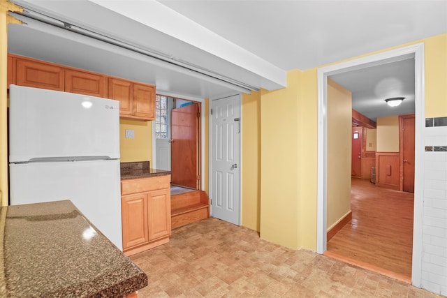 332 E 240th St, Bronx, NY 10470 - kitchen with freestanding refrigerator and dark stone counters