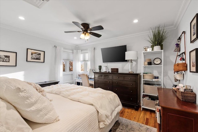 bedroom featuring wood finished floors, ornamental molding, recessed lighting, and a ceiling fan