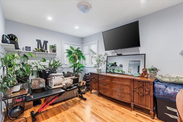 workout room featuring light wood-type flooring and recessed lighting