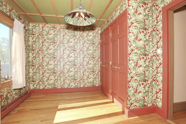 1143 State Route 17b, Mongaup Valley, NY 12762 - empty room with wallpapered walls, light wood finished floors, baseboard heating, and baseboards