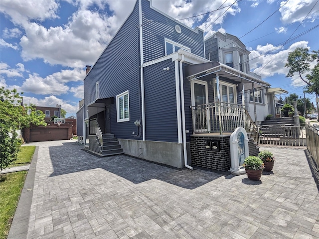 58-09 61st St, Maspeth, NY 11379 - view of side of home featuring a chimney
