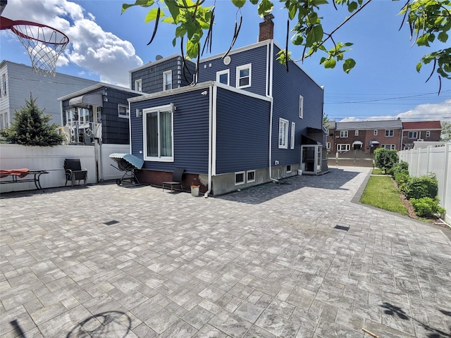 58-09 61st St, Maspeth, NY 11379 - back of house with a chimney and a patio area