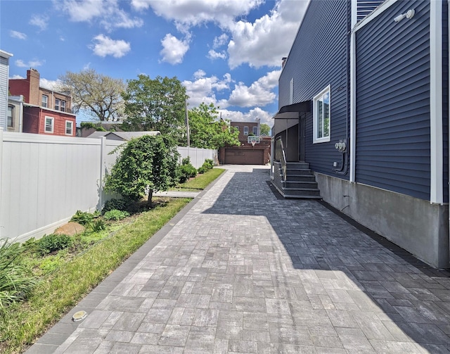 58-09 61st St, Maspeth, NY 11379 - view of patio / terrace with a garage and entry steps