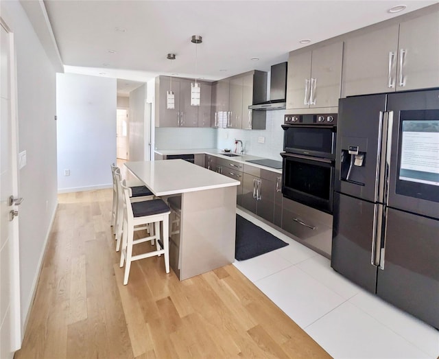 58-09 61st St, Maspeth, NY 11379 - kitchen with black appliances, wall chimney exhaust hood, gray cabinets, backsplash, and light countertops