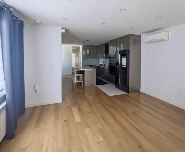 58-09 61st St, Maspeth, NY 11379 - kitchen with a wall mounted air conditioner, light wood-type flooring, a kitchen breakfast bar, a center island, and smart refrigerator