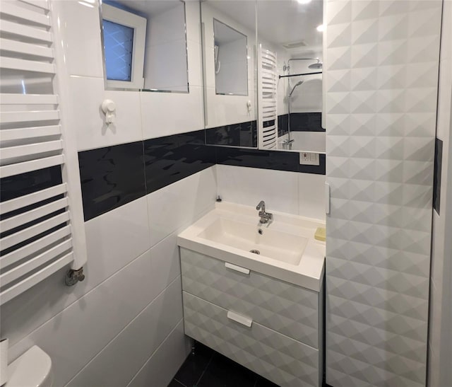58-09 61st St, Maspeth, NY 11379 - bathroom with a towel warmer, radiator, tile walls, and vanity