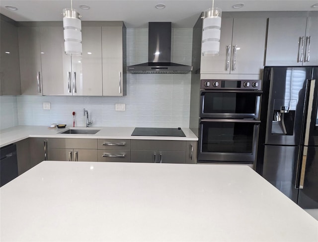 58-09 61st St, Maspeth, NY 11379 - kitchen featuring wall chimney range hood, black appliances, gray cabinets, light countertops, and tasteful backsplash