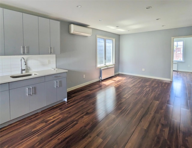 58-09 61st St, Maspeth, NY 11379 - kitchen with radiator, a wall unit AC, dark wood-style floors, gray cabinets, and recessed lighting