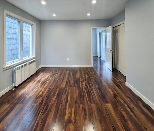 58-09 61st St, Maspeth, NY 11379 - spare room with radiator heating unit, recessed lighting, and dark wood-style flooring