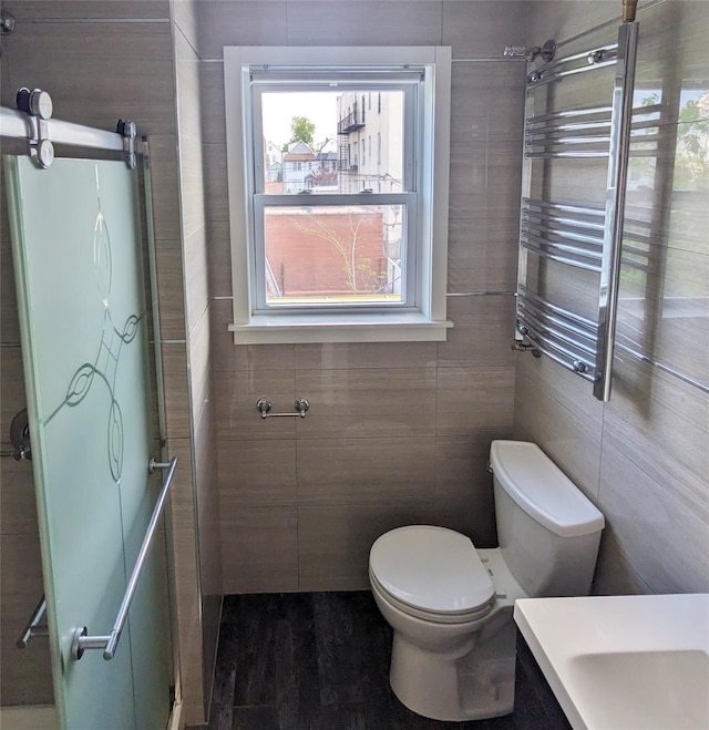 58-09 61st St, Maspeth, NY 11379 - full bathroom featuring tile walls, healthy amount of natural light, a towel warmer, a shower with door, and vanity