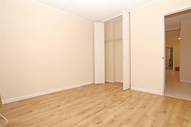 14428 Barclay Ave Unit 2C, Flushing, NY 11355 - unfurnished bedroom featuring crown molding, light wood finished floors, a closet, and baseboards
