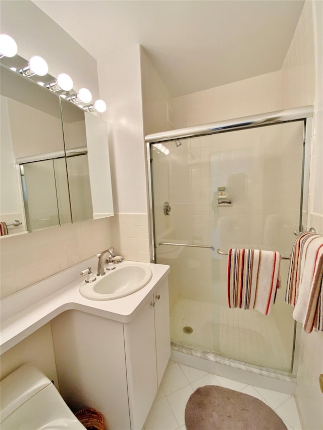 full bath featuring a shower stall, tile patterned flooring, and vanity