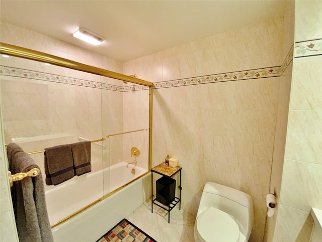full bathroom featuring tile walls, enclosed tub / shower combo, and toilet