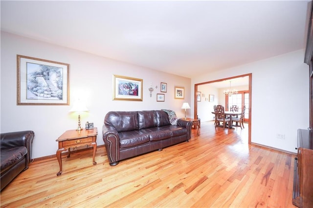 living room with a chandelier and light wood-style floors