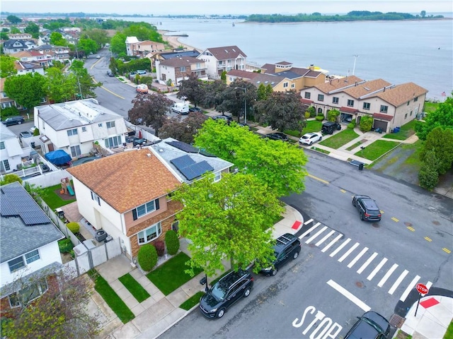 aerial view of residential area with a large body of water