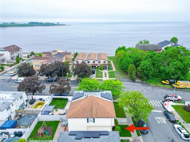 aerial view of residential area with a large body of water