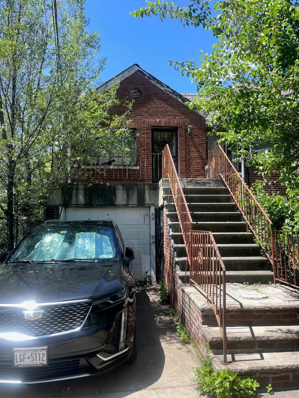 view of front of property with brick siding and a garage