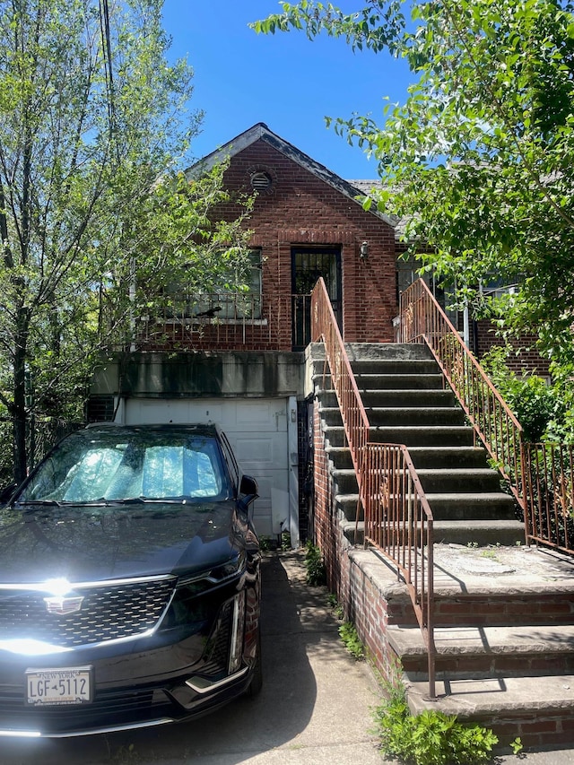 view of front of property with brick siding and a garage