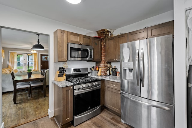 108 Homestead Ave, Maybrook, NY 12543 - kitchen with appliances with stainless steel finishes, dark wood-style flooring, backsplash, and light stone countertops