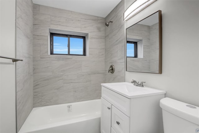 bathroom with toilet, healthy amount of natural light, vanity, and bathing tub / shower combination
