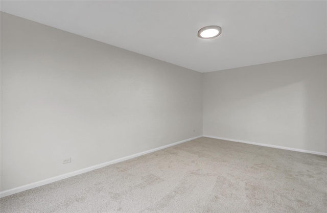 spare room with carpet flooring and baseboards