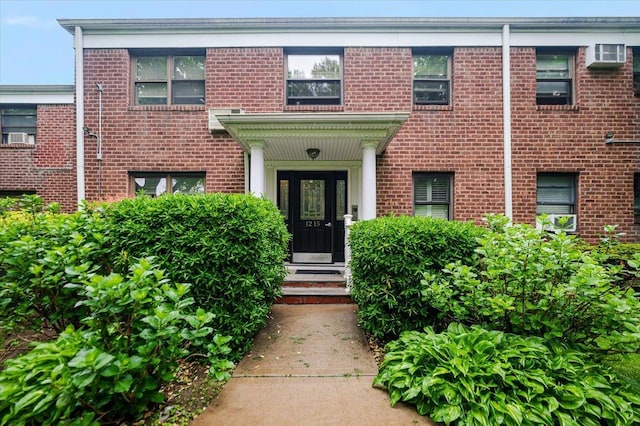 doorway to property featuring brick siding