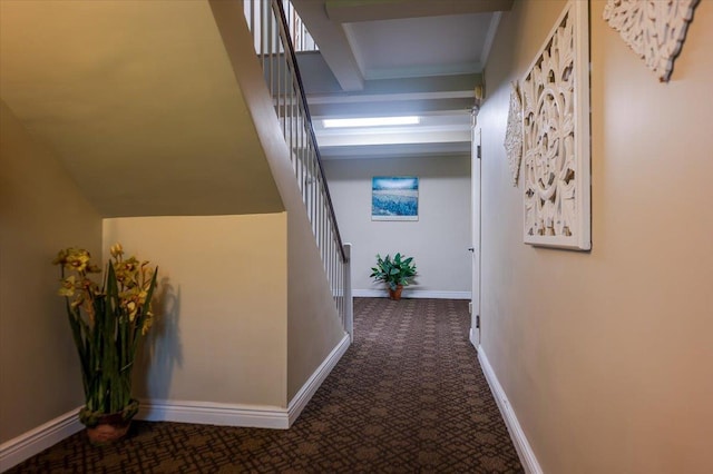 corridor featuring stairway, carpet floors, and baseboards