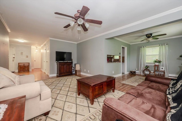 living area with a ceiling fan, ornamental molding, baseboard heating, baseboards, and light wood-style floors